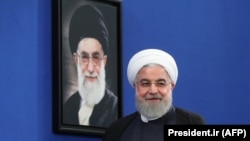Iranian President Hassan Rouhani pictured in front of a portrait of Supreme Leader Ali Khamenei, October 14, 2019
