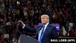 President Donald Trump gestures as he speaks during a "Keep America Great" campaign rally in Milwaukee, Wisconsin, January 14, 2020. 