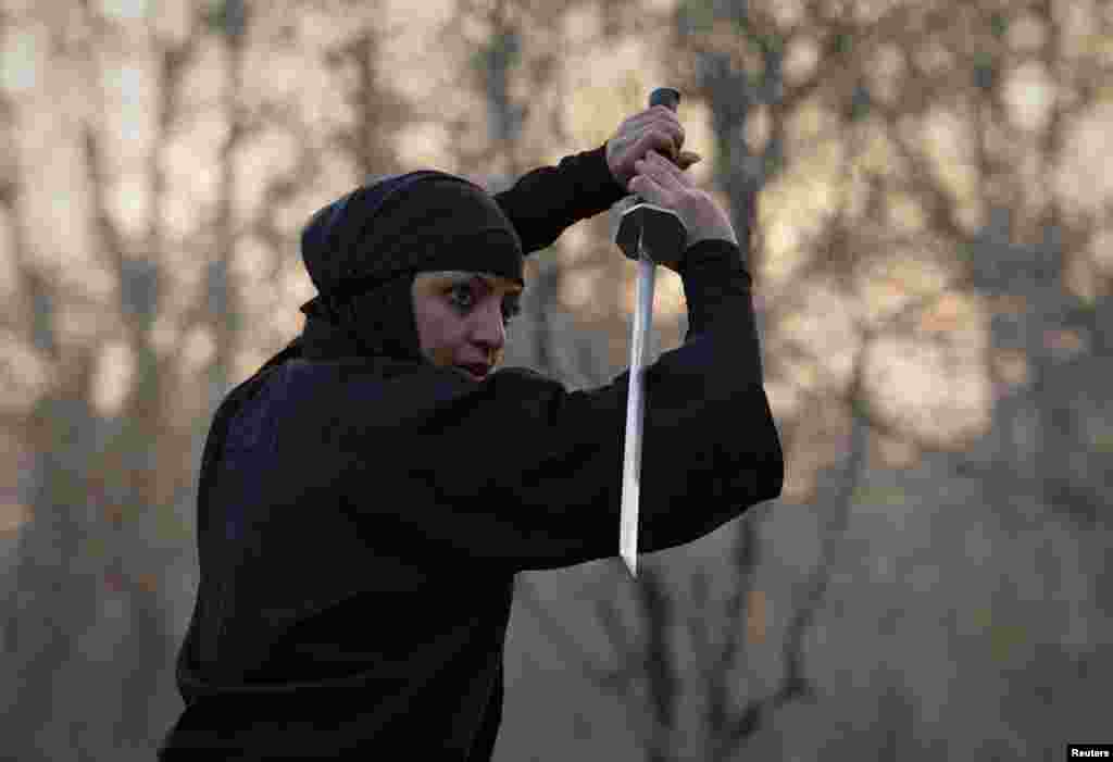 A woman participates in a ninjutsu sword drill.