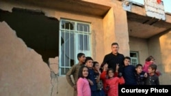 Iranian soccer (football) legend Ali Daei, with quake-stricken children in Kermanshah Province