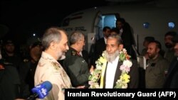 One of five freed Iranian security personnel who had been held by jihadists for a month in Pakistan, is received by military officers and media upon their arrival at an undisclosed location in Iran, November 22, 2018