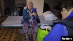 Hospital patients take shelter inside a basement during a Russian air raid on Kharkiv late on October 13. 