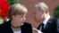 Russian President Vladimir Putin (right) speaks with German Chancellor Angela Merkel as they attend a wreath-laying ceremony at the Tomb of the Unknown Soldier by the Kremlin walls in Moscow on May 10.