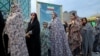 Women queue to vote at a polling station in Tehran on June 28.