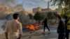 Iranian protesters block a road during a demonstration against an increase in gasoline prices in the central city of Shiraz on November 16, 2019.