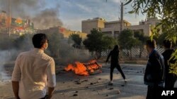 Iranian protesters block a road during a demonstration against an increase in gasoline prices in the central city of Shiraz on November 16, 2019.