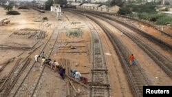 Labourers from the Pakistan Railways are seen working on railway tracks along City Station in Karachi, Pakistan on September 24.