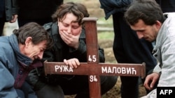 A Sarajevan Serb family mourns a victim of the Sarajevo marketplace massacre in the besieged Bosnian capital on February 7, 1994.