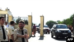 Cars carrying the four freed photographers leaves a central court in Tbilisi after a court on July 22 handed down suspended sentences of up to four years to four photographers on charges of spying for Russia.