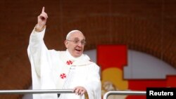 Pope Francis jokes with the crowd at the Basilica of the Madonna of Aparecida during a papal visit to Brazil in July. 