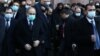 Armenian Prime Minister Nikol Pashinian (second from left) emerges from the main government building in Yerevan to lead a procession to the Erablur Military Pantheon on December 19.