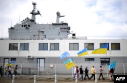 Активісти з українськими і кримськотатарськими прапорами зібралися в знак протесту біля новозбудованого військового корабля класу «Містраль», Сан-Назер, 1 травня 2014 року