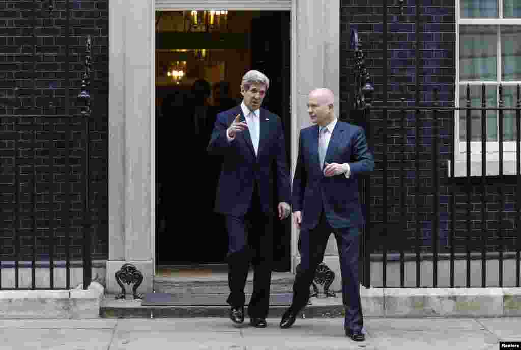 U.S. Secretary of State John Kerry (left) and Britain&#39;s Foreign Secretary William Hague leave No. 10 Downing Street in London on Kerry&#39;s first overseas trip as the top U.S. diplomat. (Reuters/Suzanne Plunkett)