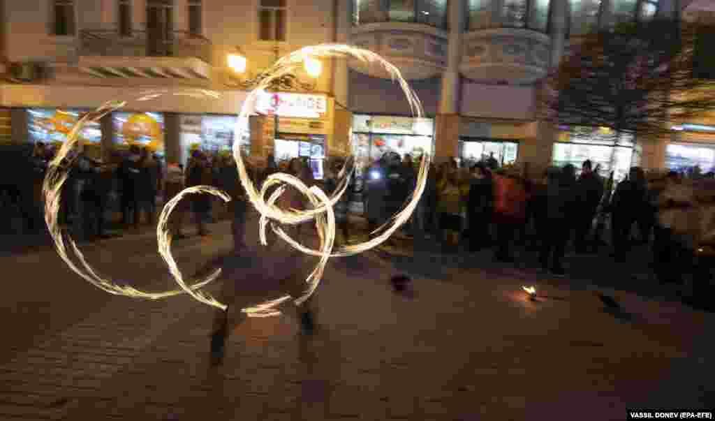 A Bulgarian performer spins fire during the opening ceremony on January 12. Some 1,500 musicians and other artists participated in the opening events.&nbsp;