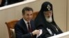 Georgia -- Prime Minister nominee and Georgian Dream coalition leader Bidzina Ivanishvili (L), accompanied by Georgian Patriarch Ilia II, attends the first session of the newly elected parliament in Kutaisi, 21Oct2012