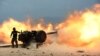 An Afghan National Army soldier fires an artillery shell during ongoing clashes between Afghan security forces and suspected Islamic State (IS) militants in Kot District on June 26.