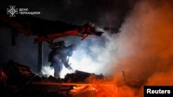 A firefighter works at a site of a Russian missile and drone strike in Ukraine's Cherkasy region on March 29, 2024. 