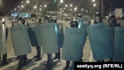 Kazakh riot police cordon off the territory of Prime Plaza after the concert by Kairat Nurtas in Almaty on August 31.