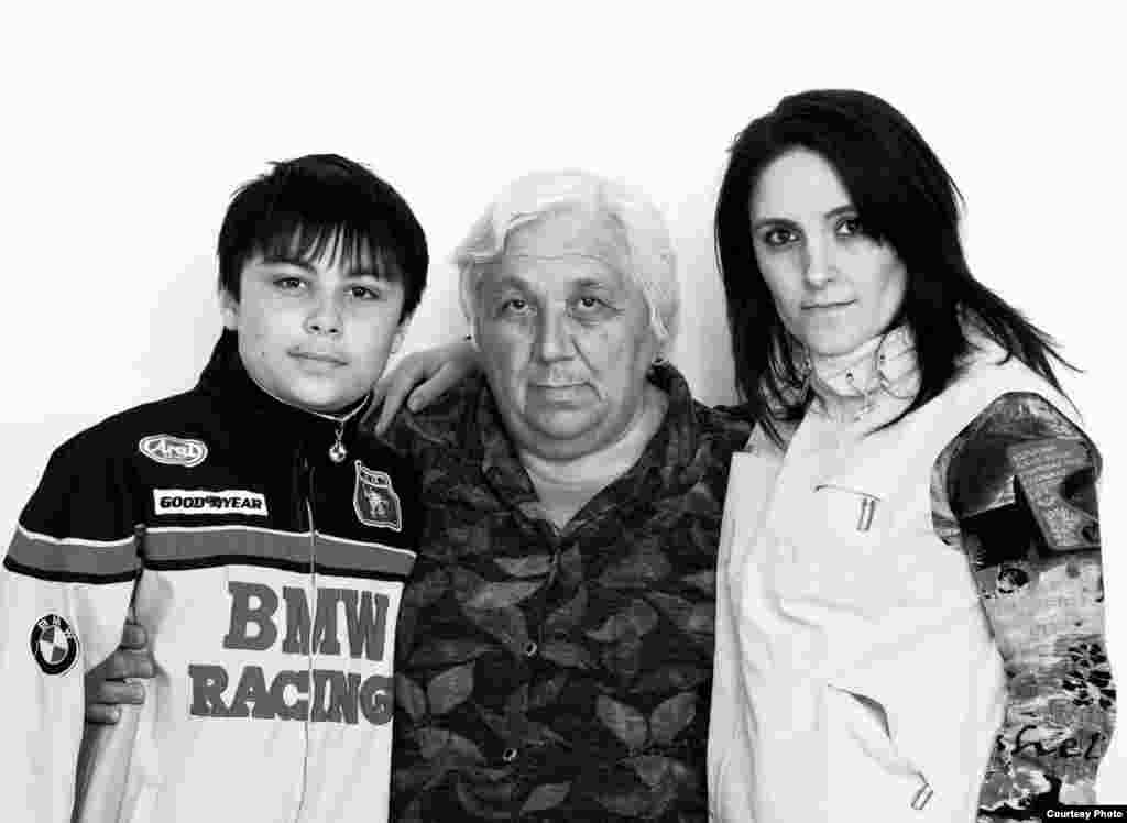 Alan Kodzhayev (left), Tamara Beroyeva, and Zalina Kodzhayeva - Two members of this family were Beslan hostages: Tamara and her grandson Alan, who was entering second grade that year. When asked how they managed to survive, Tamara says, "With God's help!... During the explosions at the end of the siege, I was sheltering Alan with my body and part of the ceiling, full of iron bars, fell down on me. It got quiet, and I came to. I whispered to Alan, 'Let me get my legs free and we'll run away.' But when I got out from under the weight, I realized Alan wasn't there. I looked for him everywhere, but he wasn't around. I started running and shouting. And then one of the terrorists came toward me and ordered everyone to move to the cafeteria. I told him, 'I won't move until I find my grandson!' But he hit me with his gun, so I followed him. I went into the cafeteria, and there was Alan, hiding between the furnace and the table, in his underwear, holding a cookie in one hand and a glass of wat