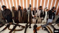 Former Taliban militants surrender arms in the western Afghan city of Herat.