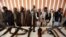 Former Taliban militants surrender arms in the western Afghan city of Herat.