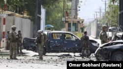 Foreign troops with NATO-led Resolute Support Mission investigate at the site of a suicide attack in Kabul on September 5.