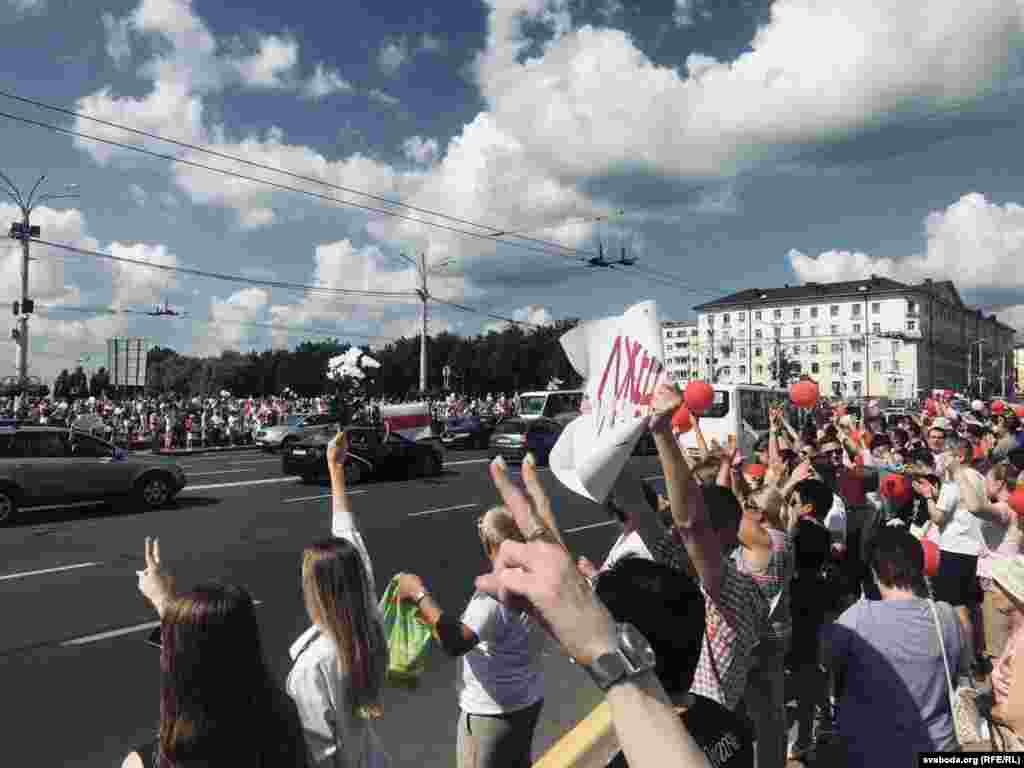 Сотні людей з квітами, повітряними кульками та біло-червоно-білими прапорами йшли до площі Перемоги в Мінську