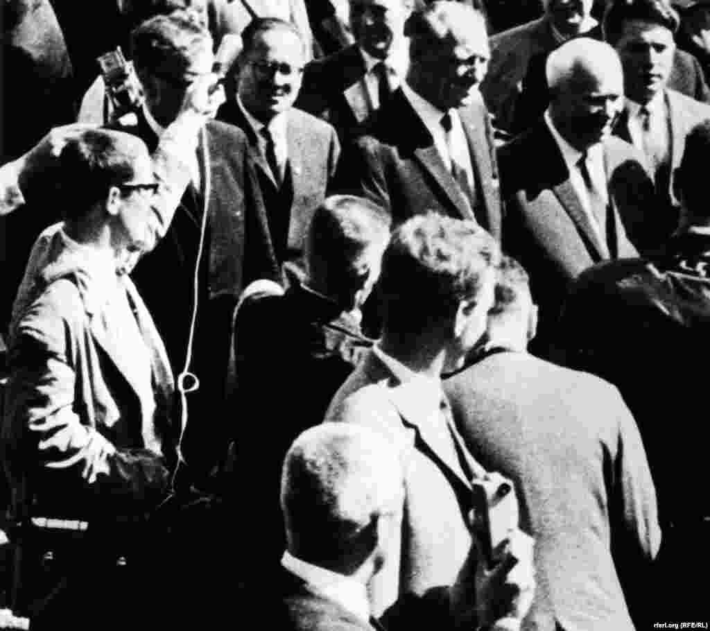 A Radio Free Europe journalist scrambles to get a front-row seat for a news conference with Soviet leader Nikita Khrushchev in 1962.
