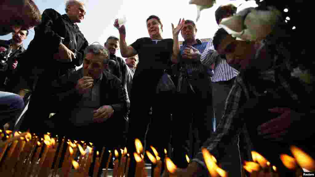 The family members of killed soldiers of the Yugoslav Army lay flowers and light candles at a place of commemoration on Dobrovoljacka Street in Sarajevo. (Reuters/Dado Ruvic)