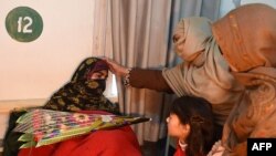 Relatives of 2014 Peshawar school attack victims meet with a student victim of Bacha Khan University at a hospital in Charsadda on January 21.