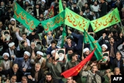 Iranians chant slogans as they march in support of the government near the Imam Khomeini grand mosque in the capital, Tehran, on December 30.