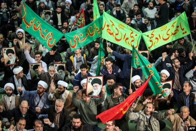 Iranians chant slogans as they march in support of the government near the Imam Khomeini grand mosque in the capital, Tehran, on December 30.
