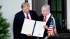 U.S. President Donald Trump (left) and Israeli Prime Minister Benjamin Netanyahu hold up the Golan Heights proclamation after a meeting in the the White House in Washington on March 25.