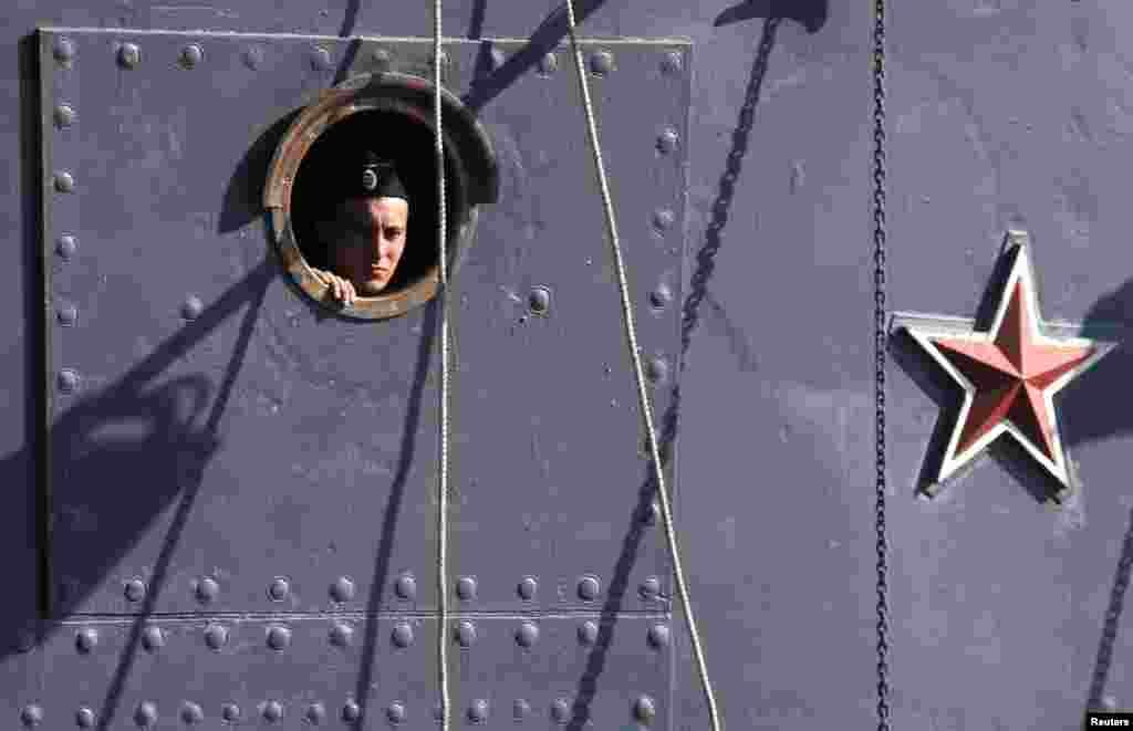 A Russian sailor is seen aboard the cruiser "Aurora" museum in St. Petersburg. The former cruiser, which was used during the Russian-Japanese War in 1904-05 and the October Revolution in Russia in 1917, will be towed for planned repair works on September 21. (Reuters/Alexander Demianchuk)
