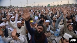 FILE: Supporters of executed Islamist Mumtaz Qadri shout slogans as they sit-in during an anti-government protest front the parliament building in Islamabad in 2016.
