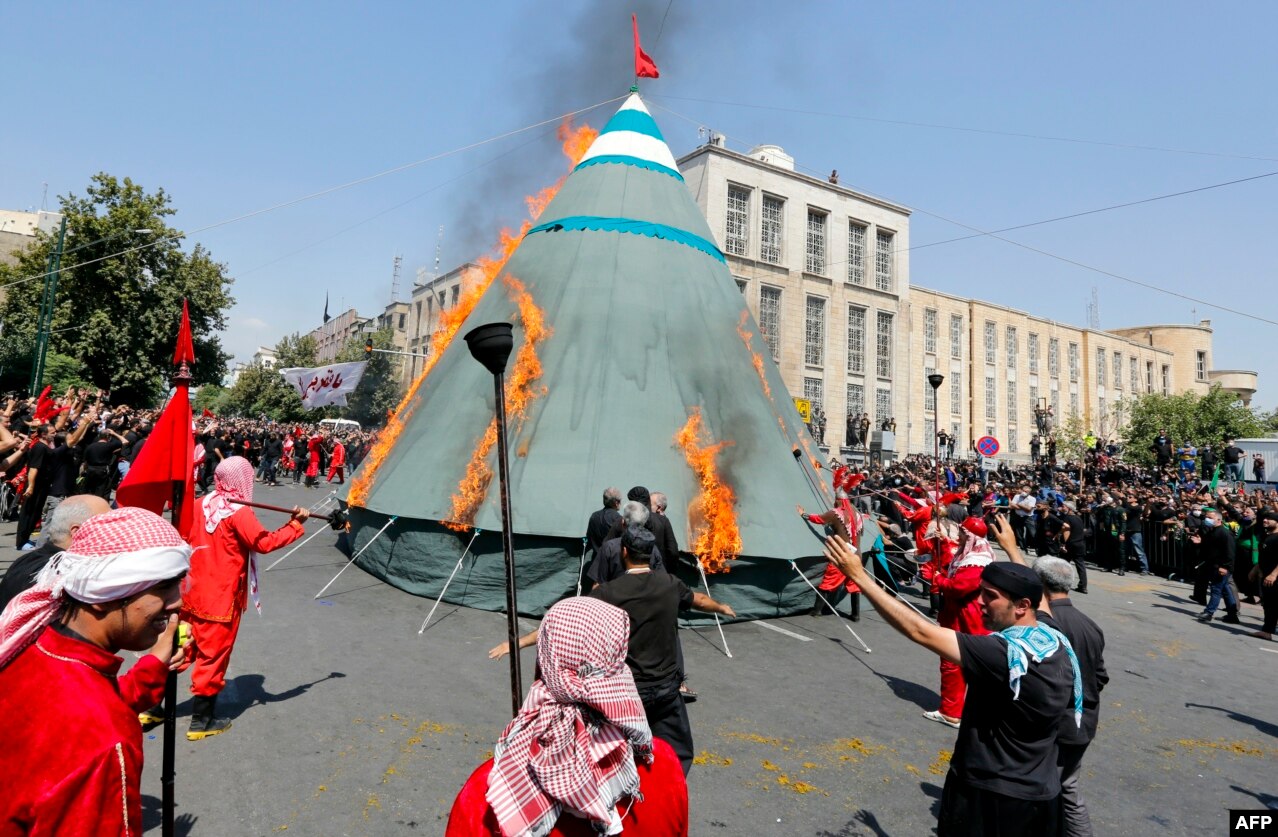 Iranian and Iraqi Shi&#39;ite Muslims burn a tent in Tehran on August 30 during the reenactment of the battle in Karbala in the year 680 that honors the martyrdom of Imam Hussein, the grandson of the Prophet Muhammad.