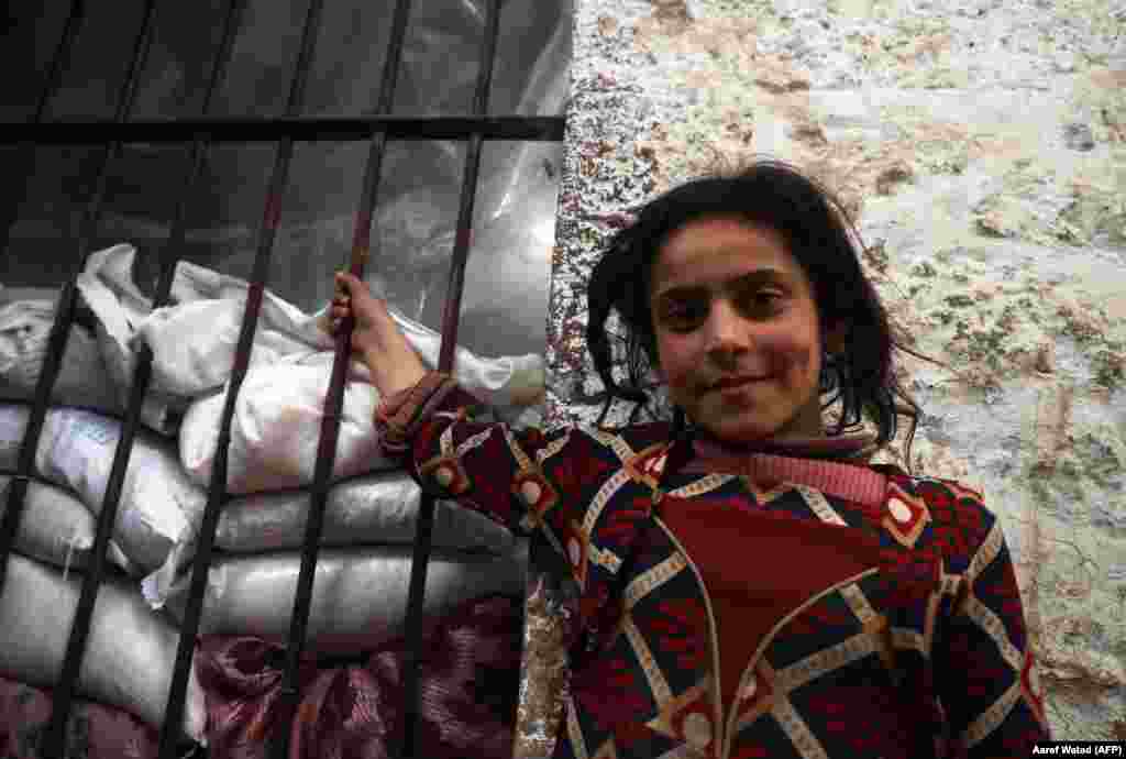 A displaced Syrian girl is pictured in a former jail turned into a makeshift shelter in the northwestern city of Idlib. (AFP/Aaref Watad)
