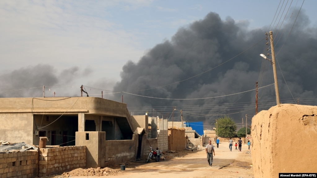Smoke clouds rise from the scene of clashes between the Syria democratic forces (SDF) and Turkish troops and their Syrian opposition allies near Ras al-Ain town, October 17, 2019