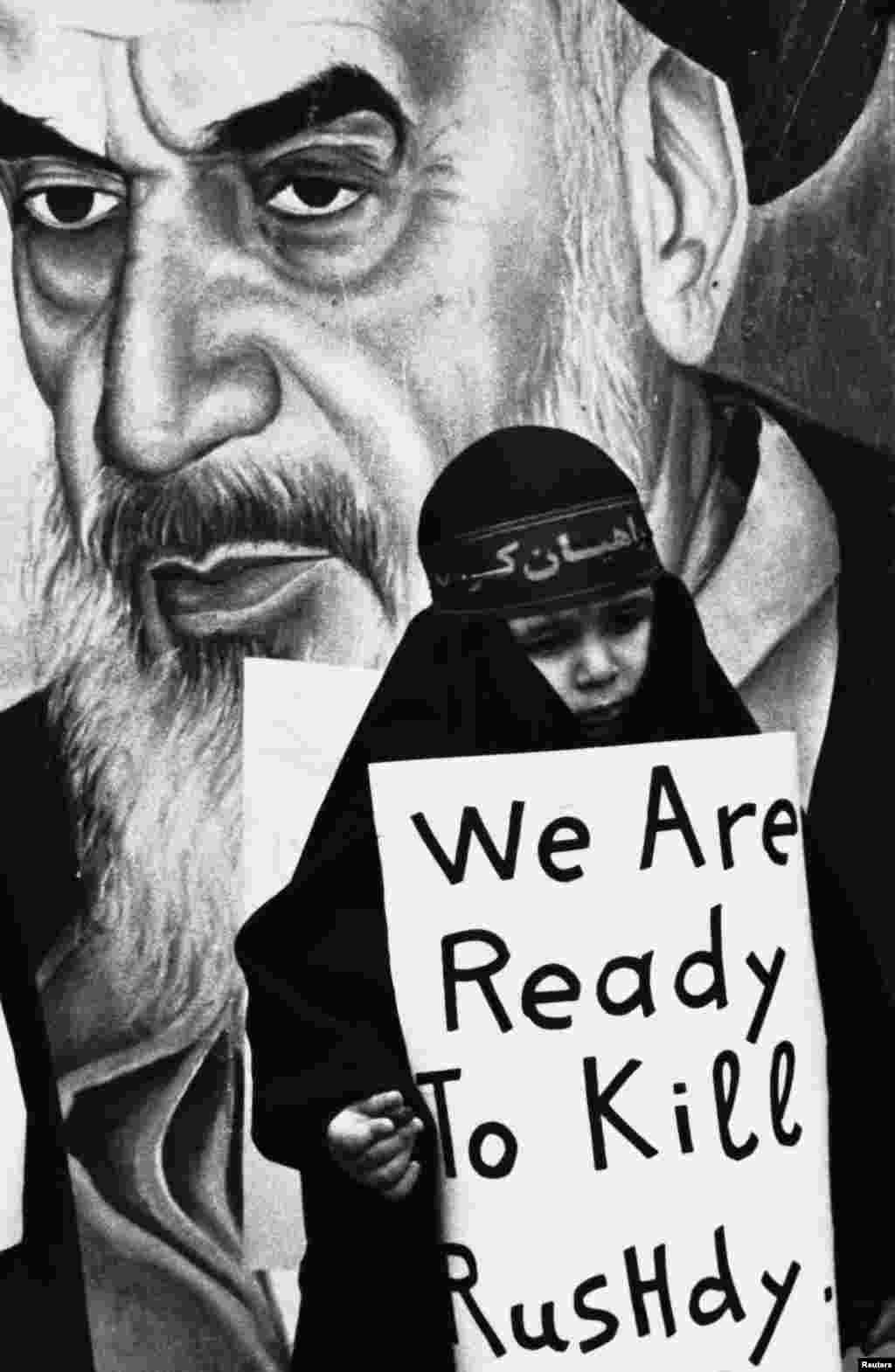 A black-clad girl carries a sign vowing to kill author Salman Rusdie during a pro-Iranian rally in Beirut's southern suburb in February 1989.