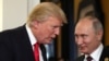 U.S. President Donald Trump (left) and Russian President Vladimir Putin talk before an APEC summit session in Vietnam on November 11.