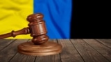 UKRAINE – Judge's law gavel with flag of Ukraine on desk