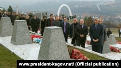 Kosovar President Hashim Thaci (right) visits a memorial in the village of Recak on International Human Rights Day.