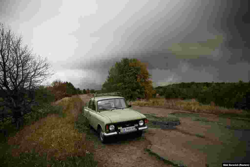 A car is left abandoned on a road near the scene of explosions at a Defense Ministry munitions depot in Ukraine&#39;s Chernihiv region, northeast of Kyiv. (Reuters/Gleb Garanich)