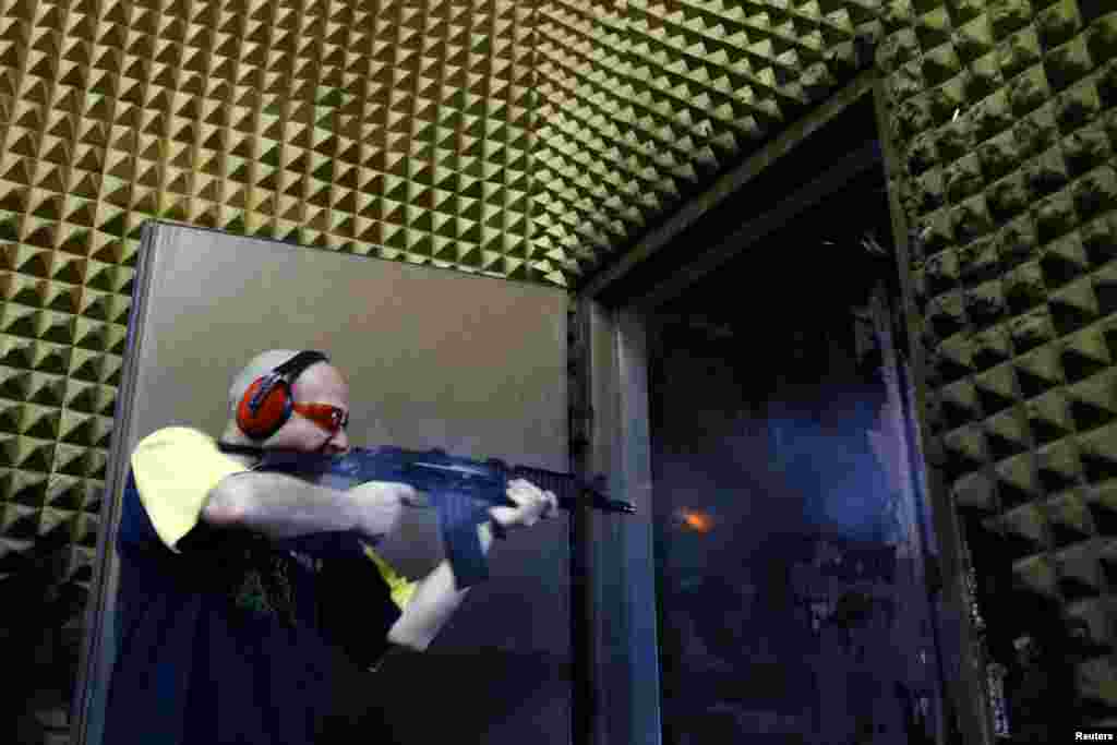 A weapons tester fires a prototype assault rifle at the shooting range.