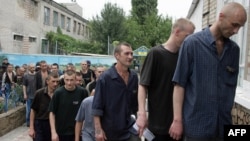 Tubercular patients at a penal colony in the Ukrainian village of Zhdanovka, in the Donetsk region, line up to enter the canteen.