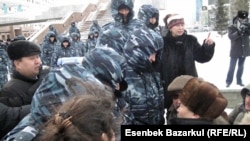 Mortgage holders and investors are met by security forces in Almaty on March 15.