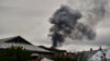 NAGORNO-KARABAKH -- Smoke rises behind houses after shelling in Stepanakert/Xankandi, the main city in the breakaway region of Nagorno-Karabakh, October 7, 2020 