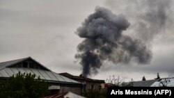 NAGORNO-KARABAKH -- Smoke rises behind houses after shelling in Stepanakert/Xankandi, the main city in the breakaway region of Nagorno-Karabakh, October 7, 2020 