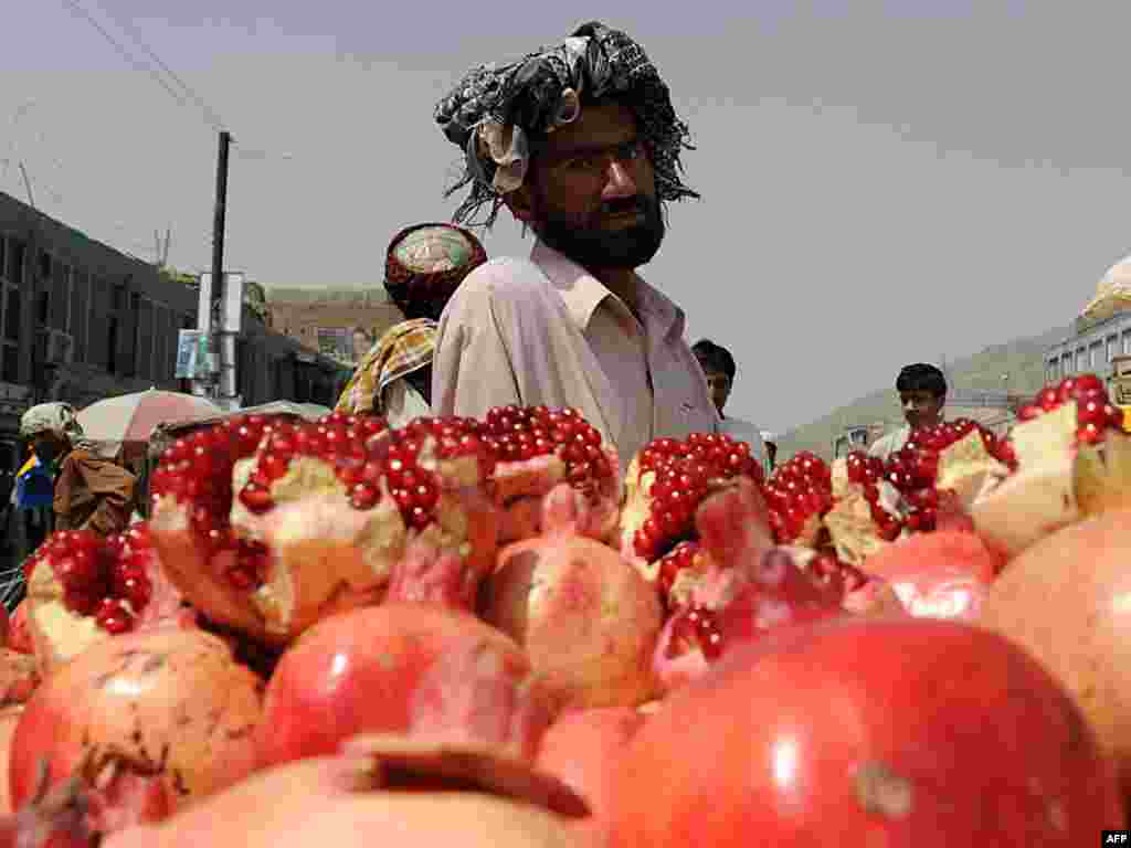 An Afghan pomegranate vendor waits for customers in Kabul on August 24. A report by the office of the UN High Commissioner for Human Rights claims that over a third of Afghans live in "absolute poverty" and about the same number are only slightly above the poverty line. It blamed corruption in Afghanistan, and the international community for ignoring the basic needs of people. Photo by Shah Marai for AFP 