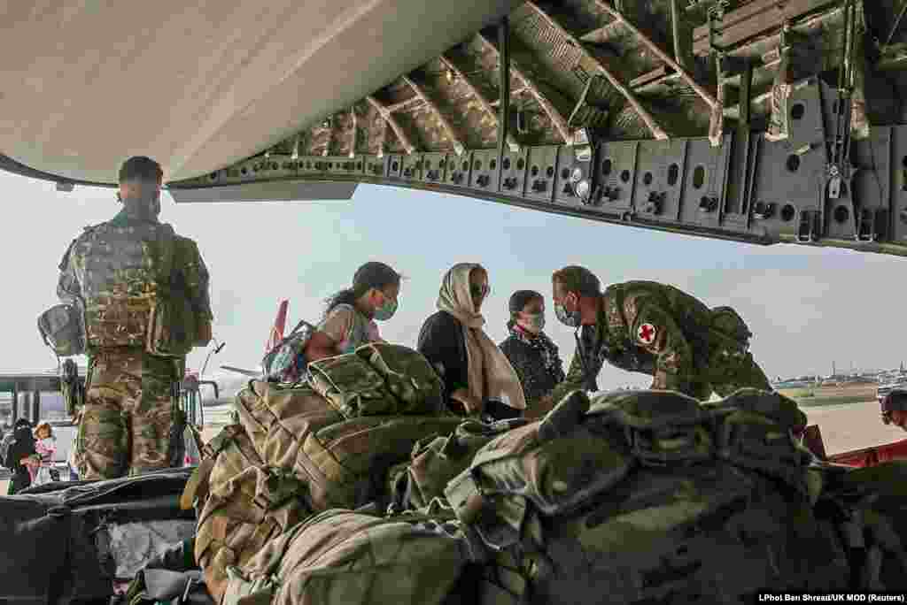 British citizens and dual nationals in Afghanistan board a military plane for evacuation from Kabul airport.